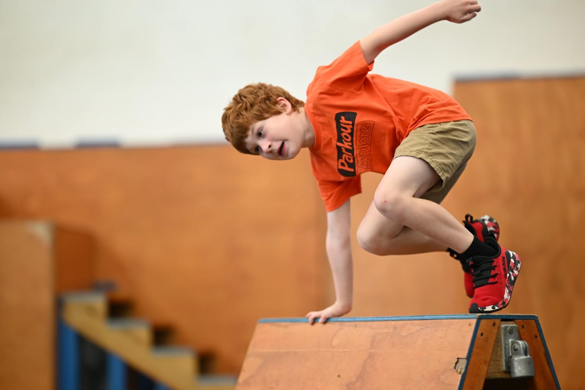 Student performing a rail vault in parkour class