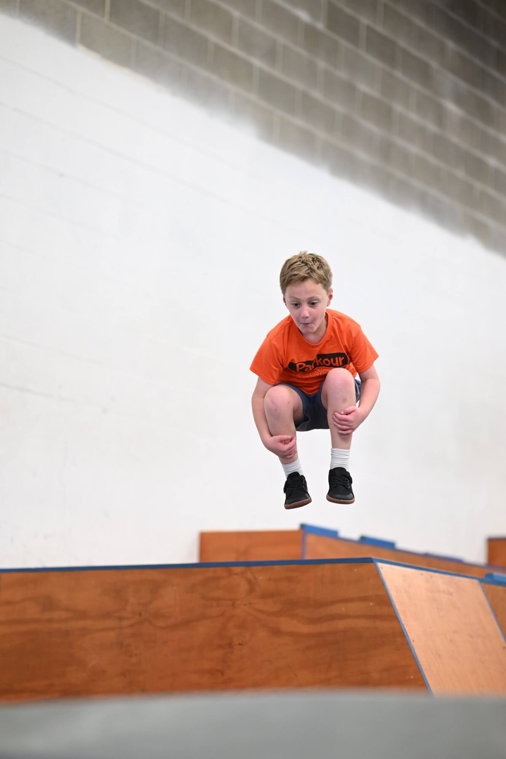 Student landing from a jump during parkour class