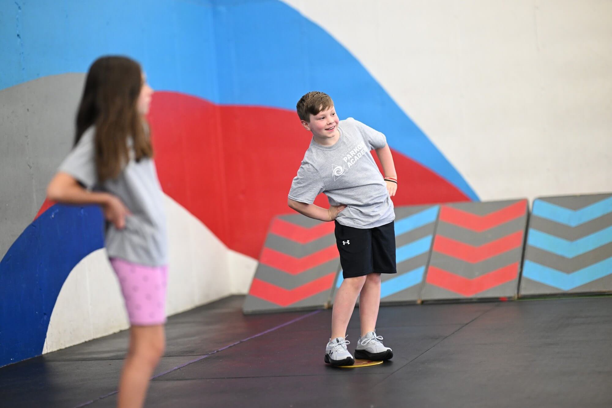 Teen students working together in parkour class