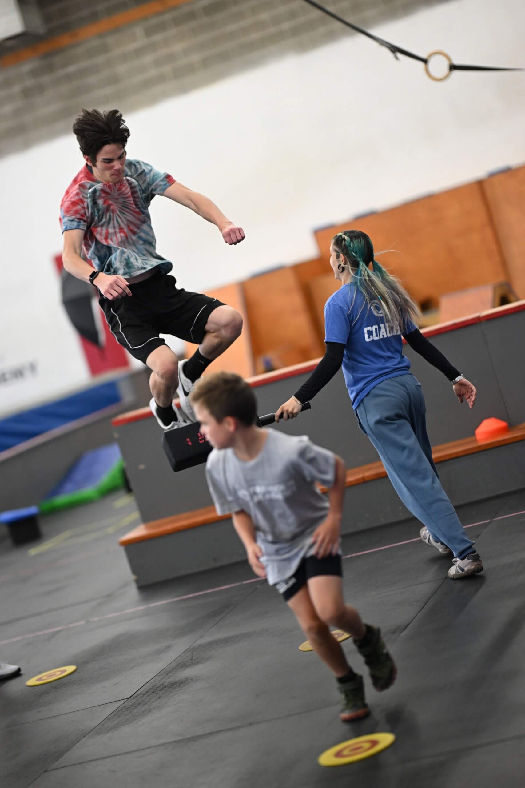Student vaulting over an obstacle during a parkour class